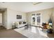 Cozy living room with neutral decor, comfortable seating, and access to a balcony at 4939 Silver Feather Cir, Broomfield, CO 80023