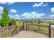 Inviting back deck with views of the neighborhood and blue sky at 676 Fossil Bed Cir, Erie, CO 80516