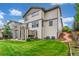 Backyard with lawn, walkway, garden, and patio with stairs to deck at 676 Fossil Bed Cir, Erie, CO 80516