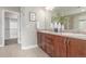 This bathroom features a double vanity with walk-in closet at 676 Fossil Bed Cir, Erie, CO 80516
