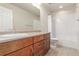 This bathroom features a vanity with wood cabinets and walk-in shower at 676 Fossil Bed Cir, Erie, CO 80516