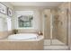 This bathroom features a walk-in shower and soaking tub at 676 Fossil Bed Cir, Erie, CO 80516