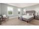 This bedroom features three windows and a gray upholstered bed frame at 676 Fossil Bed Cir, Erie, CO 80516