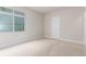 Well-lit bedroom with neutral walls, a window and a door at 676 Fossil Bed Cir, Erie, CO 80516