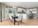 Bright dining room featuring hardwood floors and open access to the kitchen at 676 Fossil Bed Cir, Erie, CO 80516
