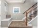 Inviting entryway features a built-in bench, stairway with carpeted steps and iron railing at 676 Fossil Bed Cir, Erie, CO 80516