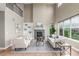 Bright living room with vaulted ceilings, a fireplace, and large windows offering views at 676 Fossil Bed Cir, Erie, CO 80516