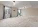 Large living room with lots of light, neutral walls, plush carpet, and sliding glass door at 676 Fossil Bed Cir, Erie, CO 80516