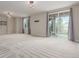 Large living room with lots of light, neutral walls, plush carpet, and sliding glass door at 676 Fossil Bed Cir, Erie, CO 80516
