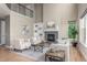 Spacious living room featuring high ceilings, hardwood floors, and a cozy fireplace at 676 Fossil Bed Cir, Erie, CO 80516