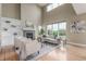 Bright living room with vaulted ceilings, a fireplace, and large windows offering views at 676 Fossil Bed Cir, Erie, CO 80516