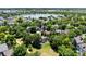 Picturesque aerial view of homes nestled among lush trees with a serene lake in the background at 1473 E 130Th Dr, Thornton, CO 80241