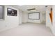 Spacious basement with movie screen, neutral carpet, and ample natural light at 1473 E 130Th Dr, Thornton, CO 80241