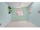 A basement area featuring a window and light blue walls, enhanced by shelving with decorative plants at 1473 E 130Th Dr, Thornton, CO 80241