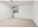 A well-lit basement area with neutral carpet and a window, offering potential for customization at 1473 E 130Th Dr, Thornton, CO 80241