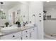 Bright bathroom featuring double vanity, modern fixtures, and tiled walk-in shower at 1473 E 130Th Dr, Thornton, CO 80241