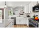 Well-appointed kitchen features white cabinets, a farmhouse sink and modern appliances at 1473 E 130Th Dr, Thornton, CO 80241