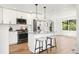Stylish kitchen with large island, stainless steel appliances, and hardwood floors at 1473 E 130Th Dr, Thornton, CO 80241