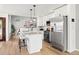 Bright, modern kitchen with large island, stainless steel appliances and hardwood floors at 1473 E 130Th Dr, Thornton, CO 80241