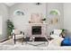 Cozy living room with brick fireplace, arched windows and modern decor at 1473 E 130Th Dr, Thornton, CO 80241