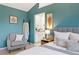 Comfortable main bedroom with gray chair and ensuite bathroom at 1473 E 130Th Dr, Thornton, CO 80241
