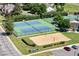 Aerial view of well-maintained tennis and sand volleyball courts within a residential community at 1473 E 130Th Dr, Thornton, CO 80241
