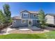 Serene backyard featuring a lovely stone patio and lush greenery, perfect for outdoor relaxation at 11957 S Swift Fox Way, Parker, CO 80134