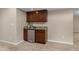 Basement wet bar equipped with cabinets, sink, beverage cooler, and granite countertop at 11957 S Swift Fox Way, Parker, CO 80134