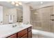 Bright bathroom featuring a glass-enclosed shower, tile, and a vanity with a white countertop at 11957 S Swift Fox Way, Parker, CO 80134