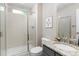 A clean bathroom with a tiled shower, granite vanity, and framed art at 11957 S Swift Fox Way, Parker, CO 80134
