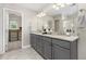 Elegant bathroom features a double vanity with granite countertops and a walk-in closet at 11957 S Swift Fox Way, Parker, CO 80134