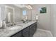 Charming bathroom showcasing double sinks, granite counters, and modern fixtures at 11957 S Swift Fox Way, Parker, CO 80134