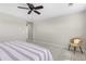 The bedroom offers a serene space with a comfortable chair and view of a striped bed at 11957 S Swift Fox Way, Parker, CO 80134