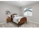This bedroom includes a plush bed and decorative nightstand below a bright window at 11957 S Swift Fox Way, Parker, CO 80134