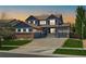 Charming two-story home boasting a well-manicured lawn and a welcoming front porch at 11957 S Swift Fox Way, Parker, CO 80134