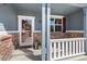 Charming front porch with brick accents, white railing, and a welcoming front door at 11957 S Swift Fox Way, Parker, CO 80134