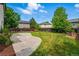 Large backyard with stone patio, lush green grass, wood fence, and planter boxes at 1248 Button Rock Dr, Longmont, CO 80504