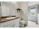 Cozy half bath features modern vanity with vessel sink, floating shelves, and wood look tile flooring at 1248 Button Rock Dr, Longmont, CO 80504