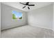 Spacious bedroom with plush carpet and natural light from a window at 1248 Button Rock Dr, Longmont, CO 80504