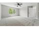 Bright primary bedroom features large window for natural light and neutral carpet at 1248 Button Rock Dr, Longmont, CO 80504