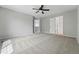 Spacious bedroom with neutral colors, carpet, and a ceiling fan at 1248 Button Rock Dr, Longmont, CO 80504