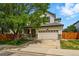 Charming two-story home featuring a well-maintained front yard and an attached two-car garage at 1248 Button Rock Dr, Longmont, CO 80504