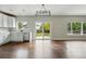 Bright eat-in kitchen features sleek white cabinets, stainless steel appliances, and a sliding door to the backyard at 1248 Button Rock Dr, Longmont, CO 80504