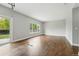 Open living area with hardwood floors, a backyard view, and easy access to outdoor spaces at 1248 Button Rock Dr, Longmont, CO 80504