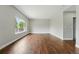 Bright living room featuring hardwood floors, neutral paint, and a large window at 1248 Button Rock Dr, Longmont, CO 80504