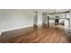 Open-concept space with hardwood floors flowing into a kitchen area, ideal for modern living at 1248 Button Rock Dr, Longmont, CO 80504