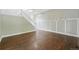Open-concept living room with gorgeous hardwood floors, fresh paint, and a staircase at 1248 Button Rock Dr, Longmont, CO 80504
