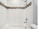 Bathroom with white tile surround and neutral accents at 56582 E 23Rd Ave, Strasburg, CO 80136