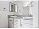 Bathroom features a double sink vanity with white cabinetry and granite countertops at 56582 E 23Rd Ave, Strasburg, CO 80136