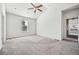 Carpeted bedroom with ceiling fan, and window at 56582 E 23Rd Ave, Strasburg, CO 80136